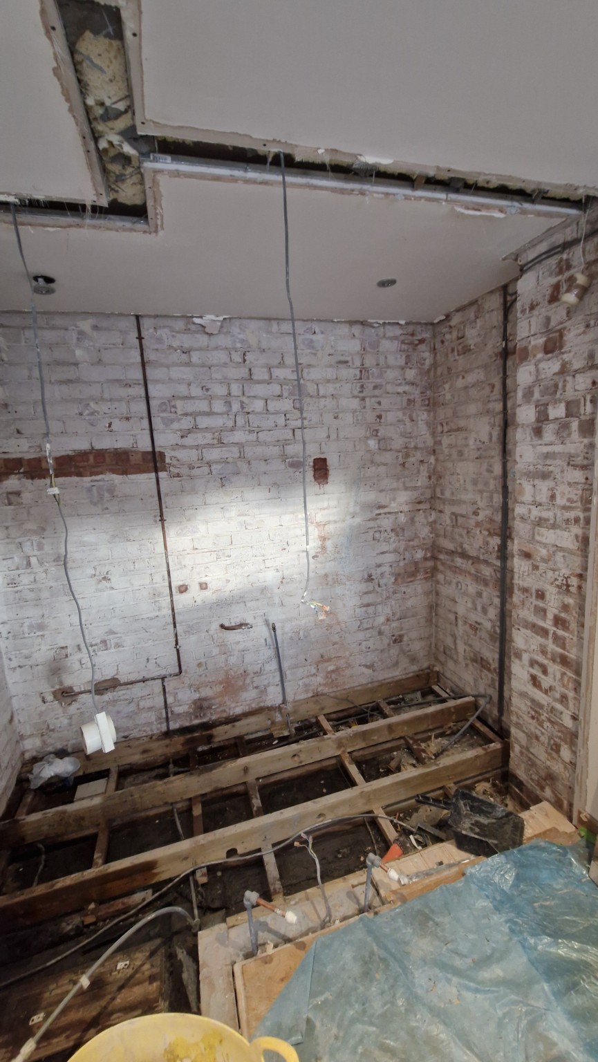 Bathroom stripped back to masonry and floor joists