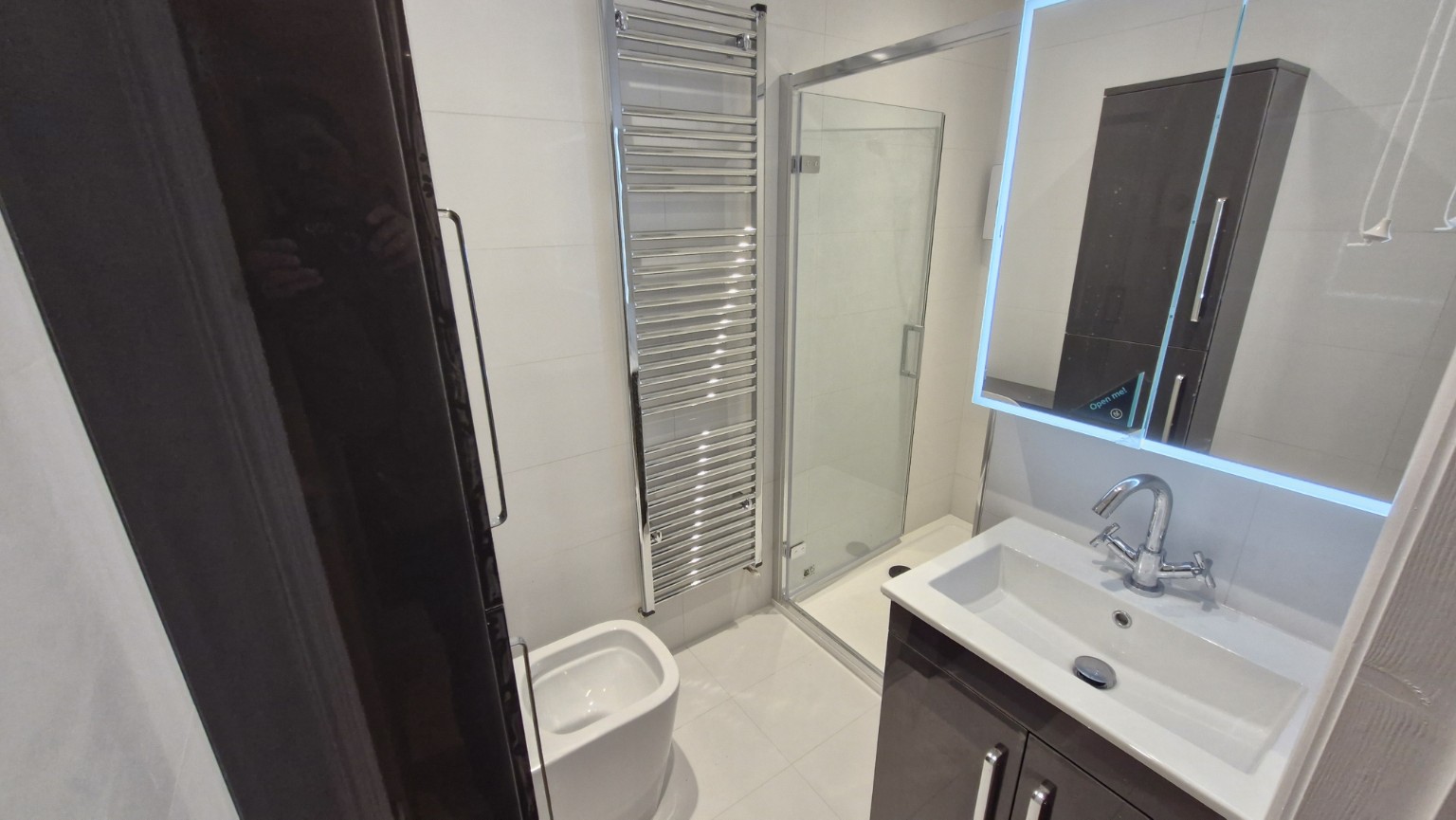 Completed washbasin, shower and towel rail