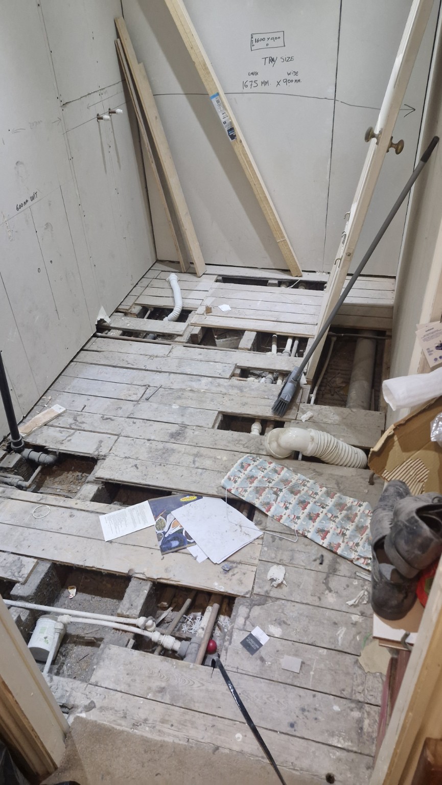 Existing floor lifted to expose plumbing