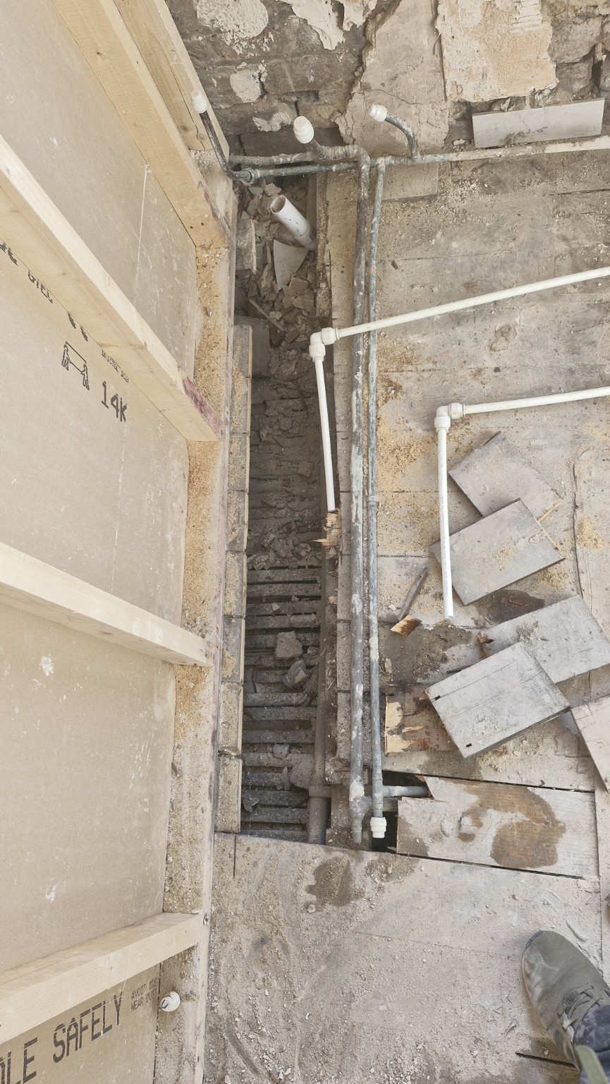 Exposed plumbing and floor void