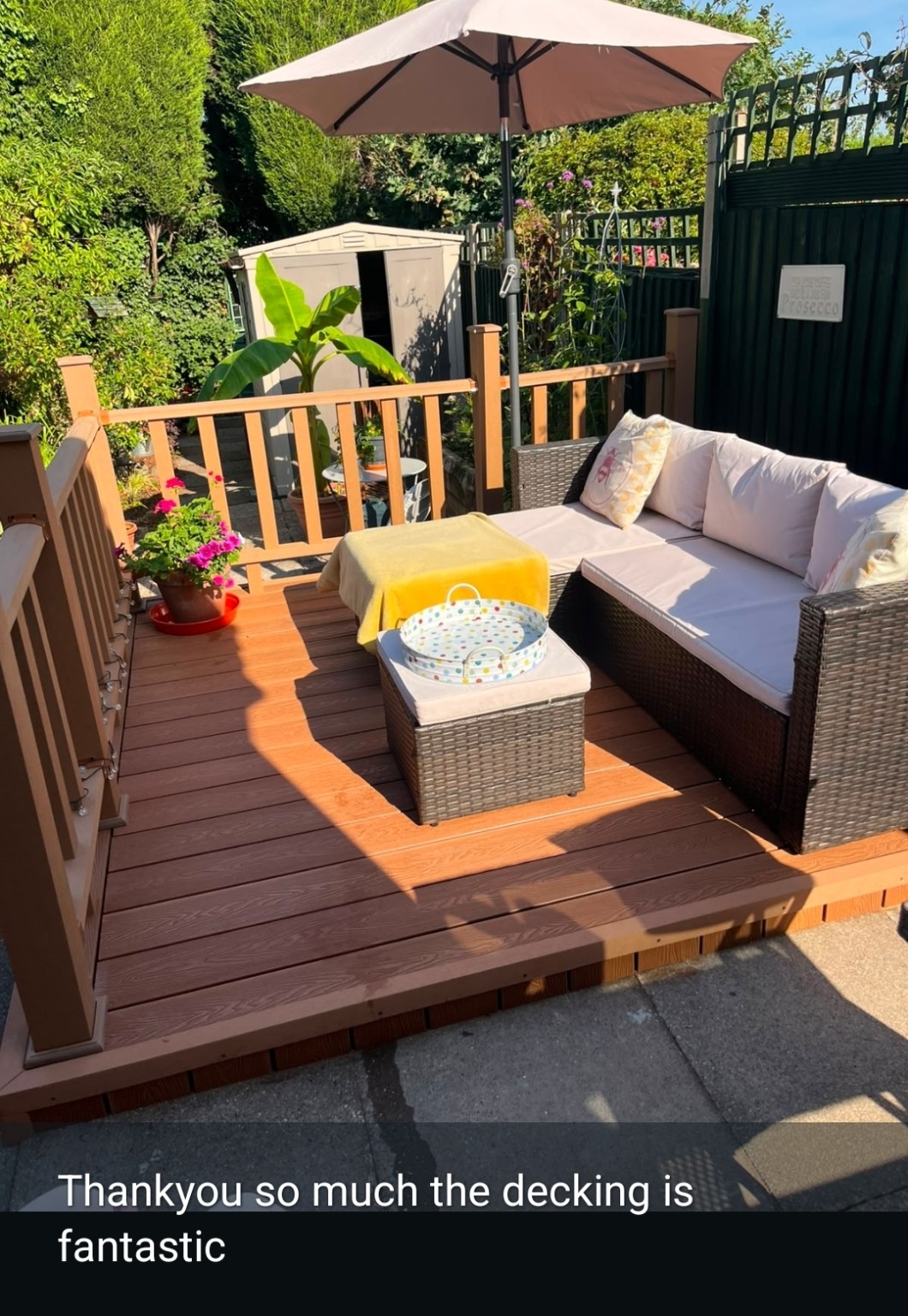 Client photograph of the completed deck furnished for use, with client feedback text