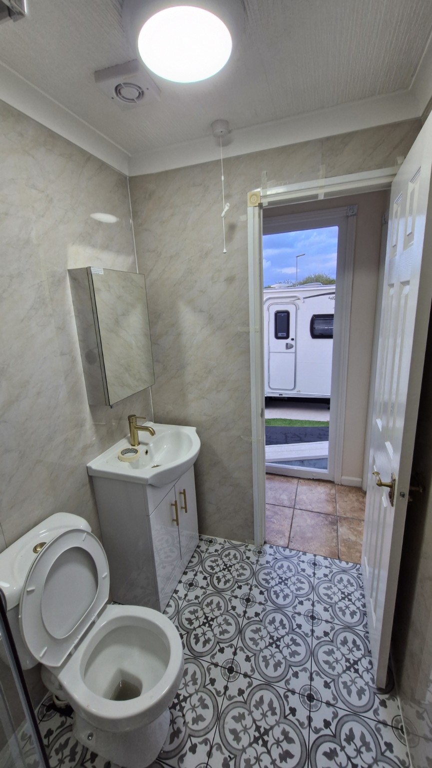 Finished shower-room vanity and patterned floor tiles