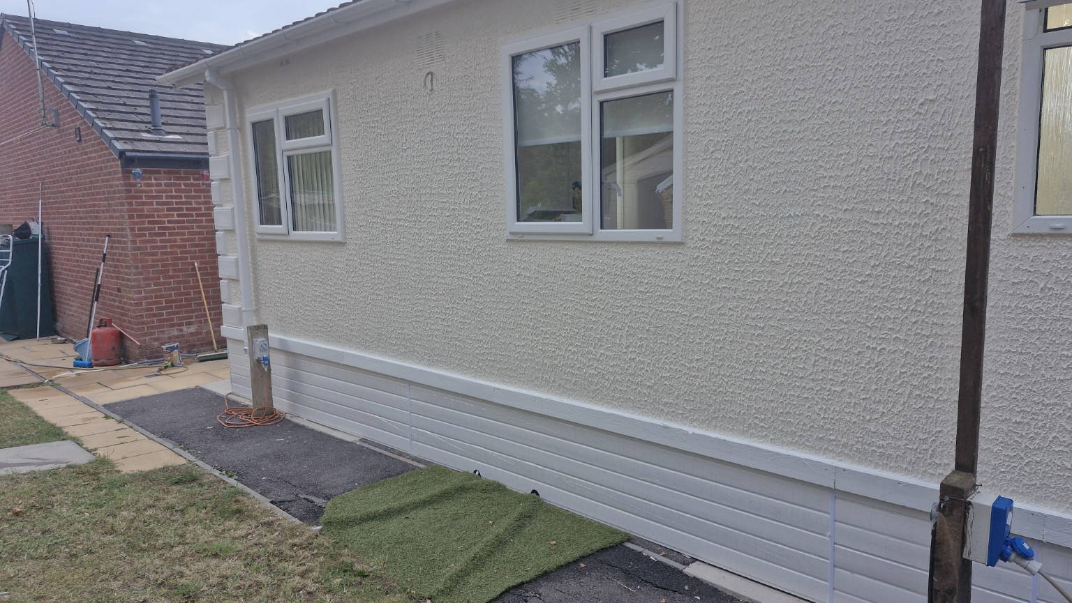 Finished exterior side view with replacement lower cladding